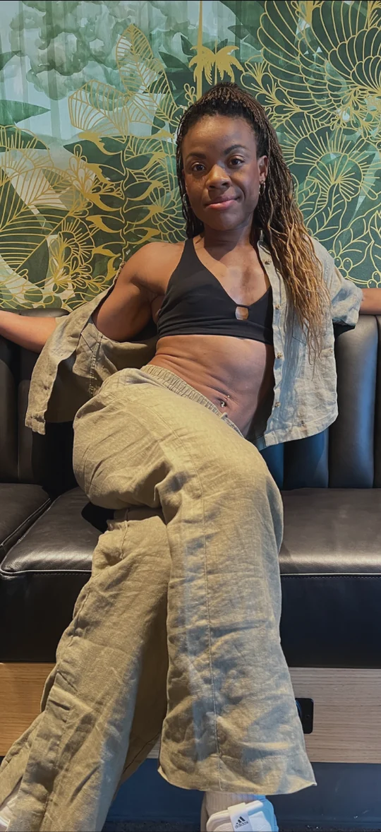Michelle in her 30s, relaxed on a couch